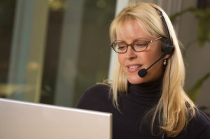 Businesswoman talks on her phone headset.