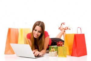 Beautiful young woman shopping over internet.