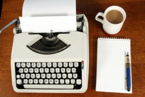 A writers typewriter and desk.